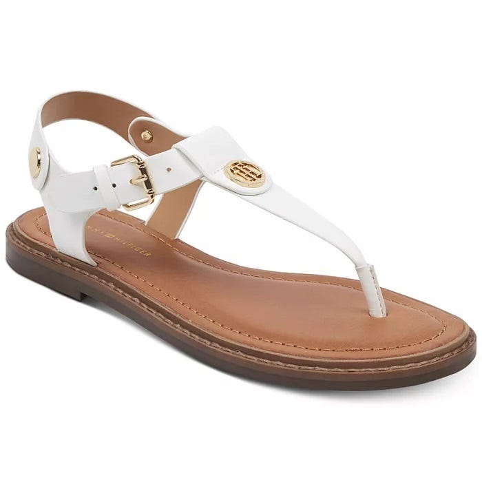 White women's sandal with a single strap, adjustable ankle closure, and gold-tone logo detail.