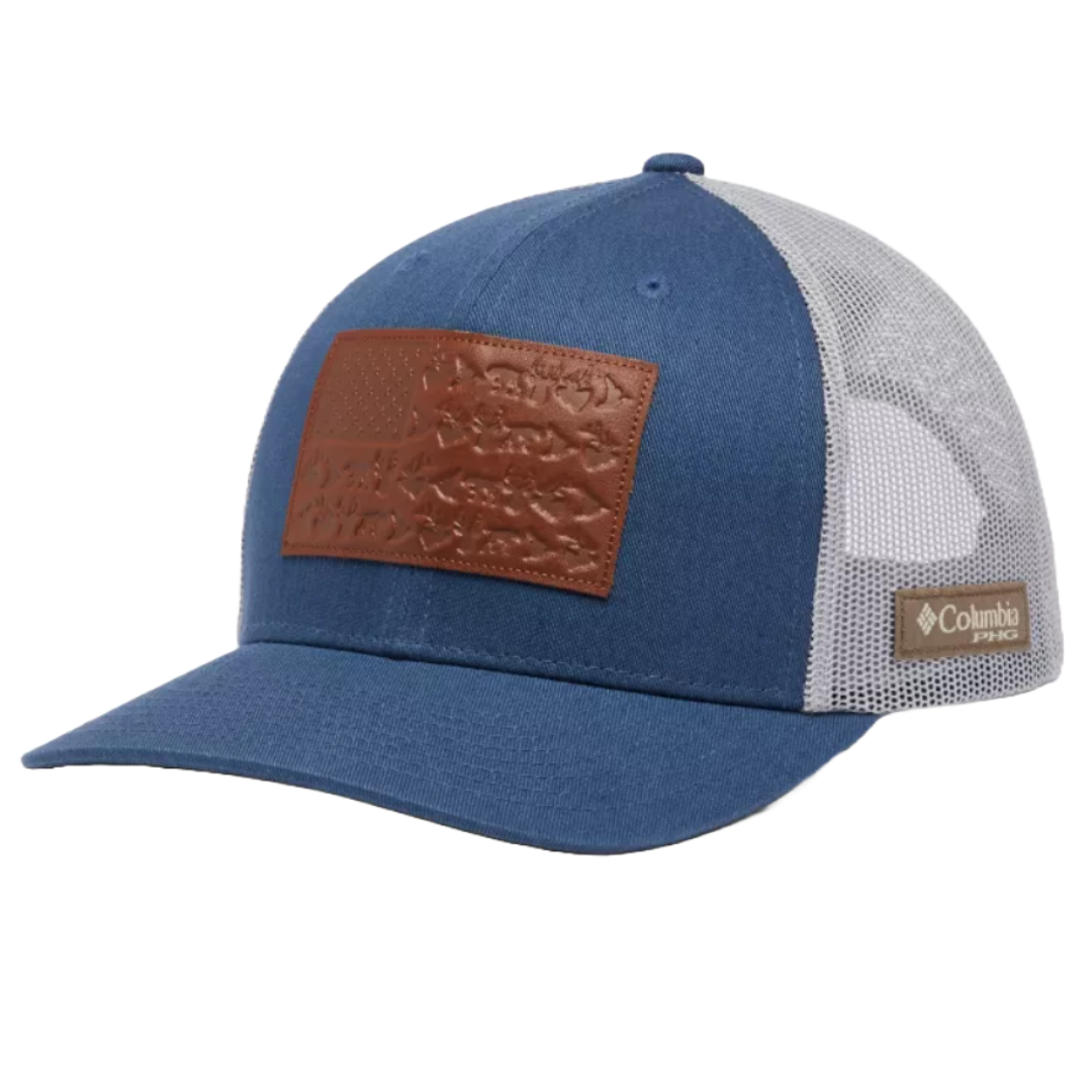 A blue Columbia PFG mesh trucker hat featuring a brown leather patch with embossed designs on the front and an adjustable snapback closure.
