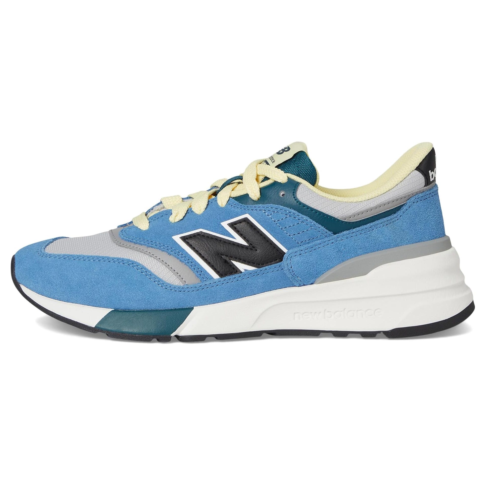 Blue and gray New Balance sneaker with a white sole, featuring a large black \“N\“ logo and yellow laces.
