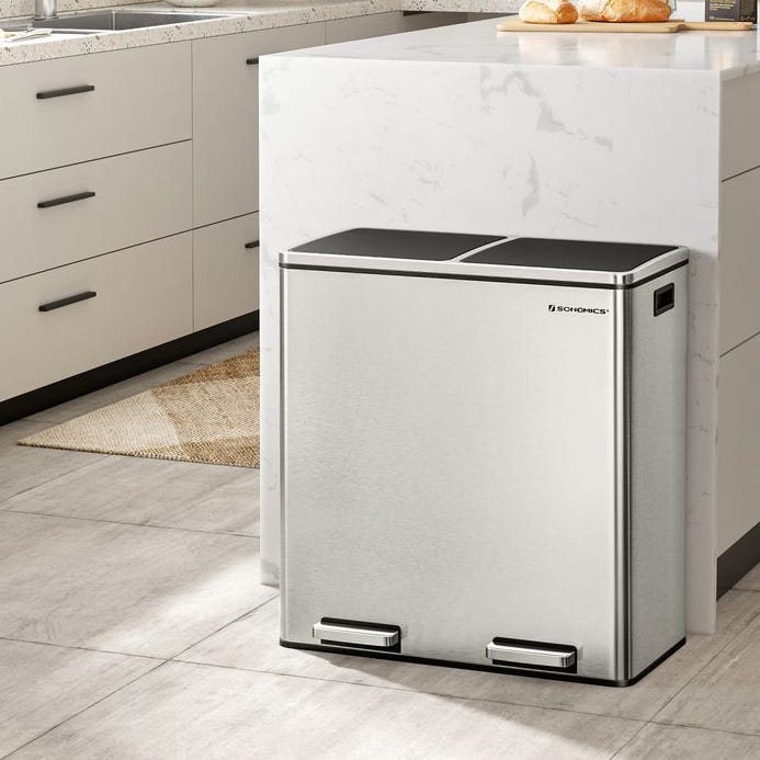 A stainless steel dual-compartment trash can with foot pedals.