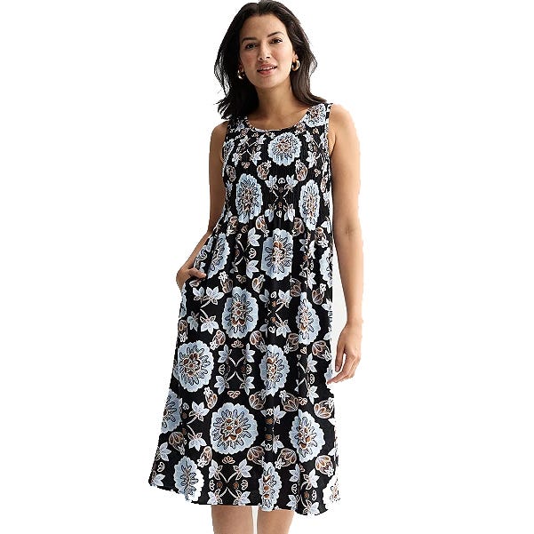 Sleeveless midi dress featuring a black background with a blue and brown floral pattern, designed with a relaxed fit and pockets for comfort.
