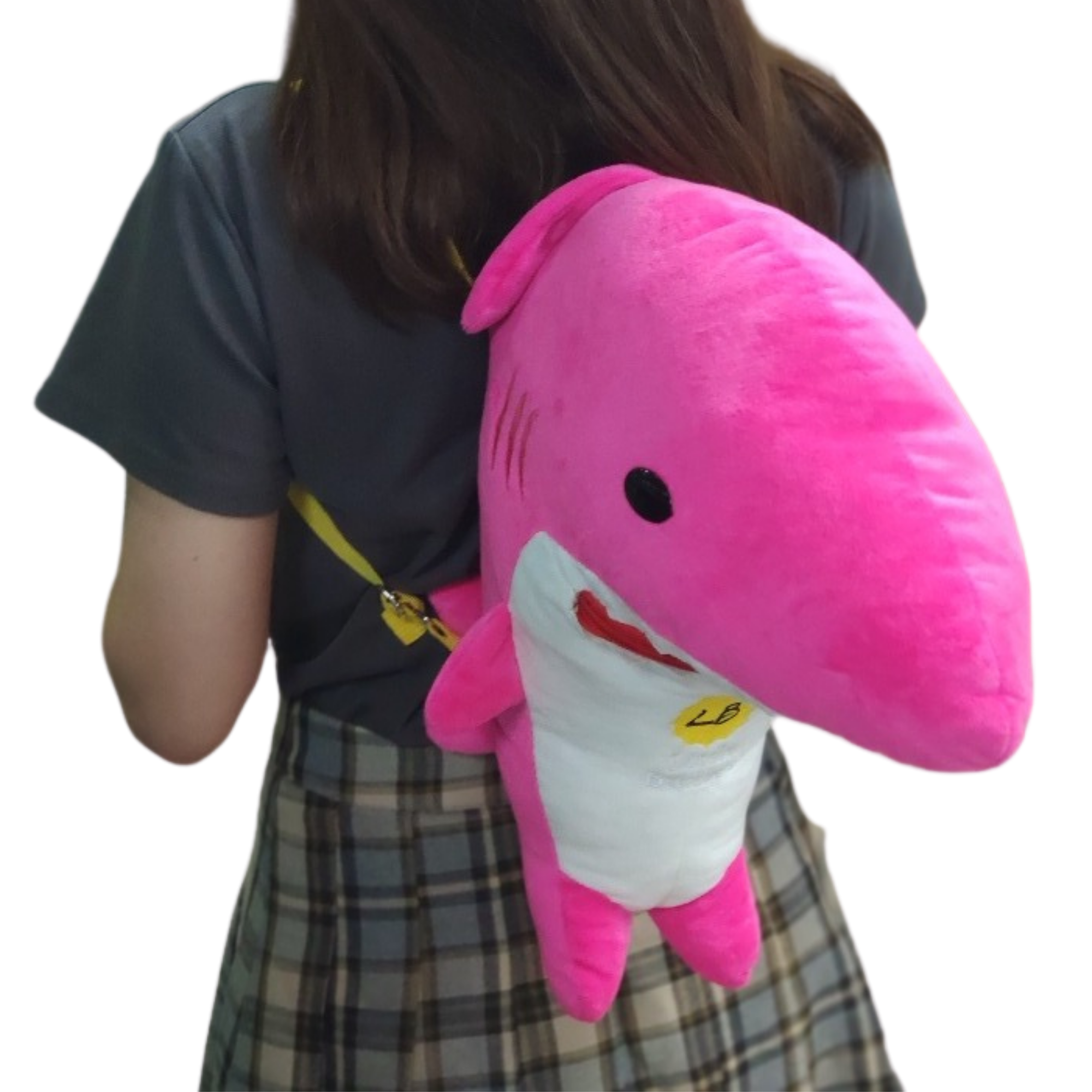 A person holding a pink shark plush toy.