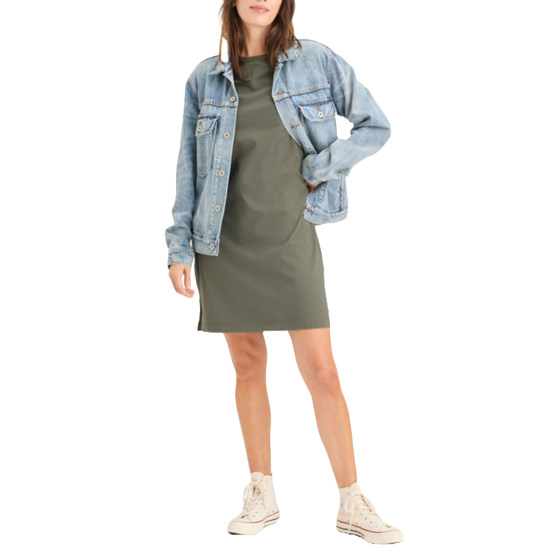 A woman is wearing an olive green casual dress with a light blue denim jacket and white high-top sneakers.