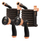 Two expandable black and copper-colored garden hoses with thumb control spray nozzles, designed for efficient watering.