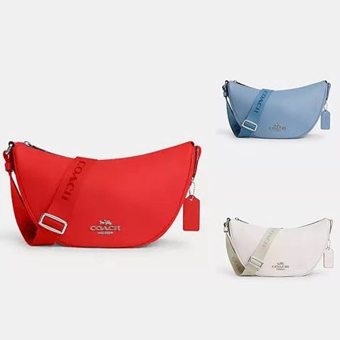 Three crescent-shaped handbags in red, blue, and white, each with a shoulder strap and designer label.