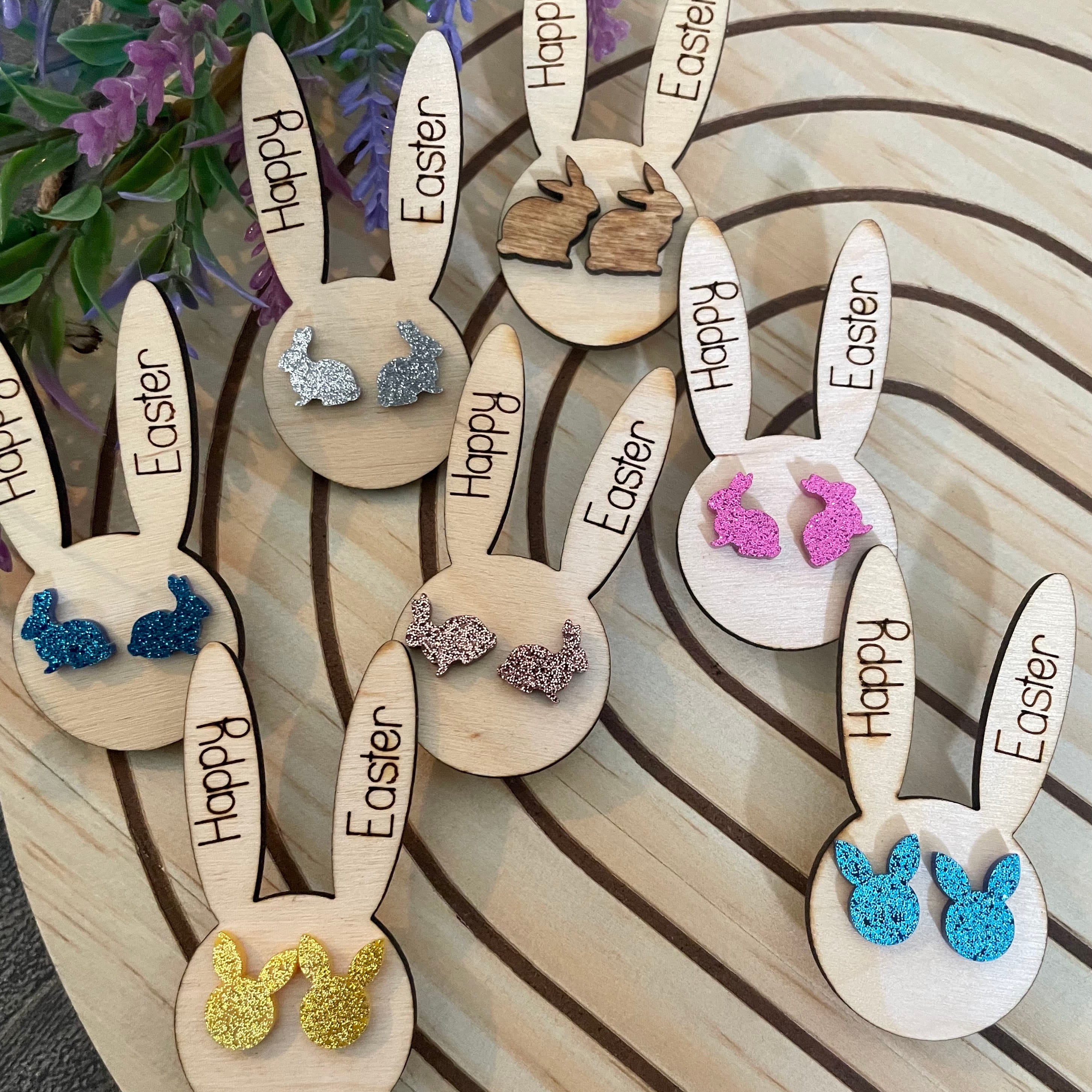 Wooden Easter bunny shapes with sparkly bunny-ear earrings in various colors.