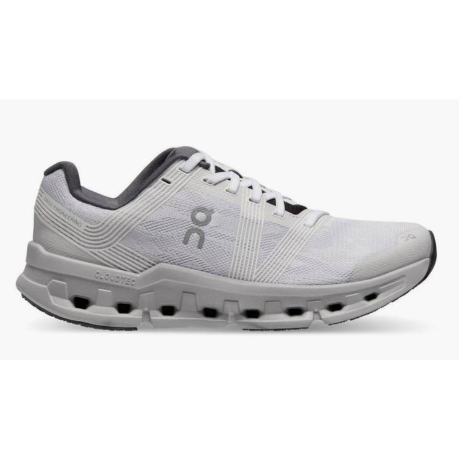 White athletic running shoe with a distinctive sole design and a logo on the side.