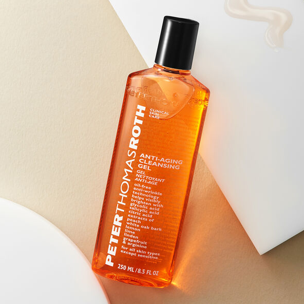 A bottle of Peter Thomas Roth Anti-Aging Cleansing Gel on a beige background.
