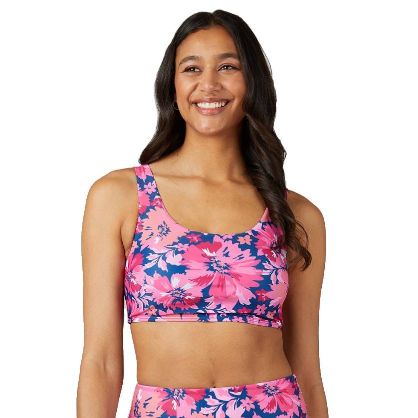 The bikini bottom features a vibrant pink and blue floral pattern, matching the top with a wide band for coverage and support.