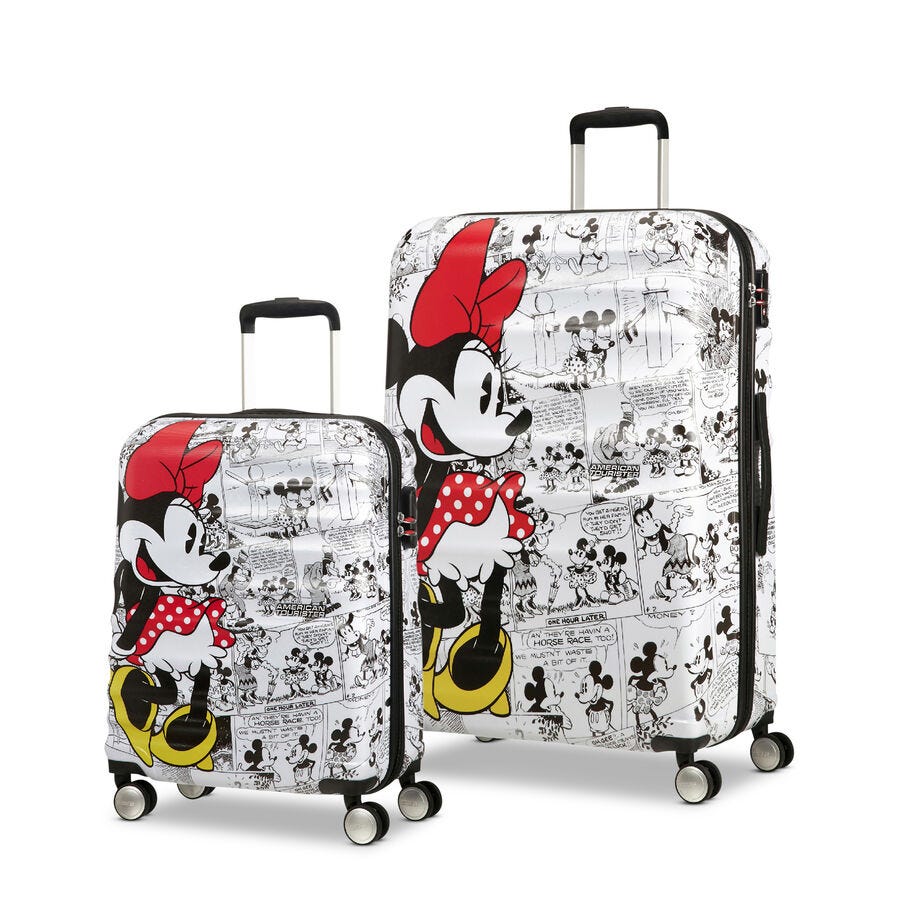 Two suitcases with black and white comic strip designs and colorful depictions of an animated female character with a red bow.