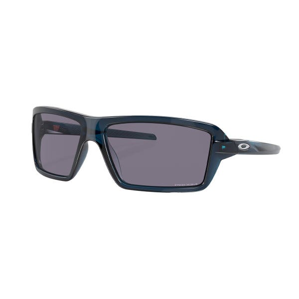 Oakley Cables Sunglasses feature a sleek rectangular design with dark blue frames and gray lenses. The iconic Oakley logo is visible on the temple.
