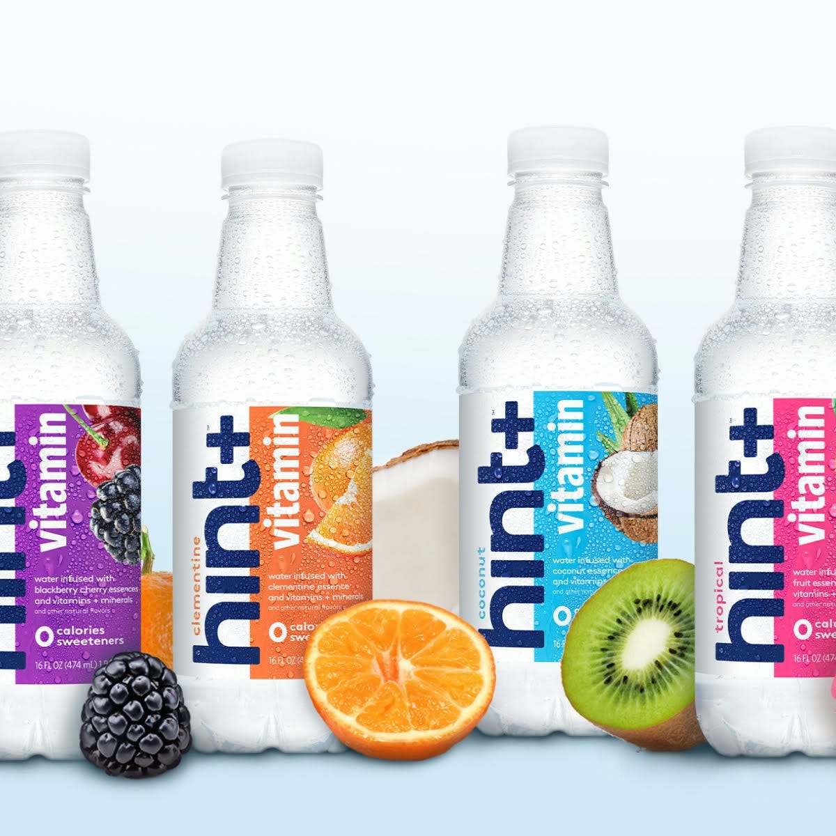 Four bottles of Hint flavored water with blackberry, orange, kiwi, and pineapple graphics.