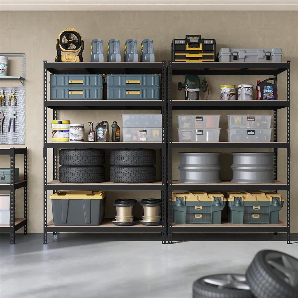 Metal shelving units storing tools, containers, car tires, and various garage items.
