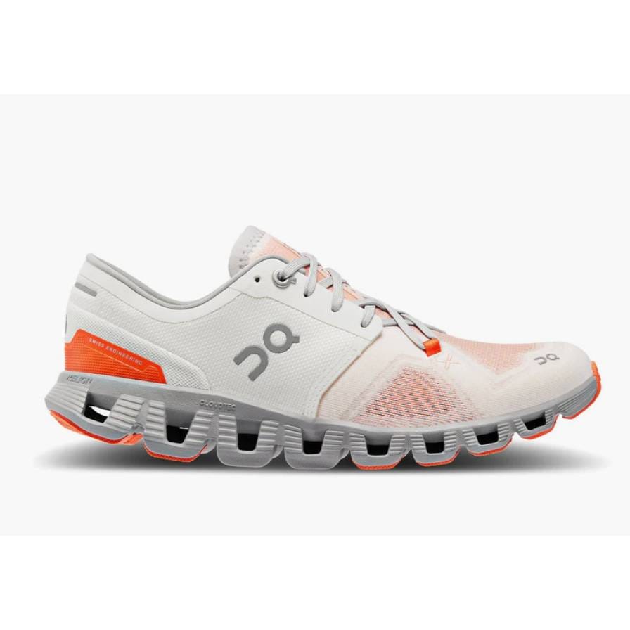 White and orange running shoe with thick, segmented soles.