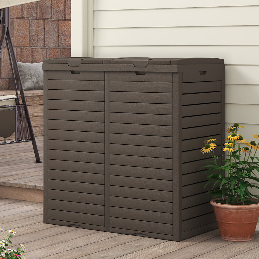 A brown outdoor storage cabinet next to a pot of yellow flowers.