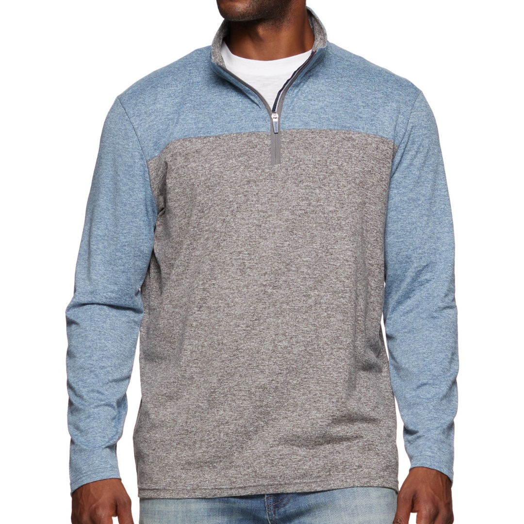The Flag & Anthem 1/4-Zip Pullover is a men's long-sleeve top, featuring a color-block design with a blue upper and sleeves, and a gray body. It has a quarter-zip collar and is paired with jeans.