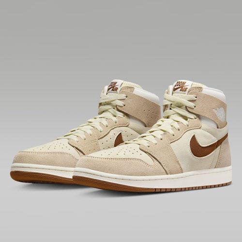 A pair of high-top, beige sneakers with white swoosh logos and brown soles.