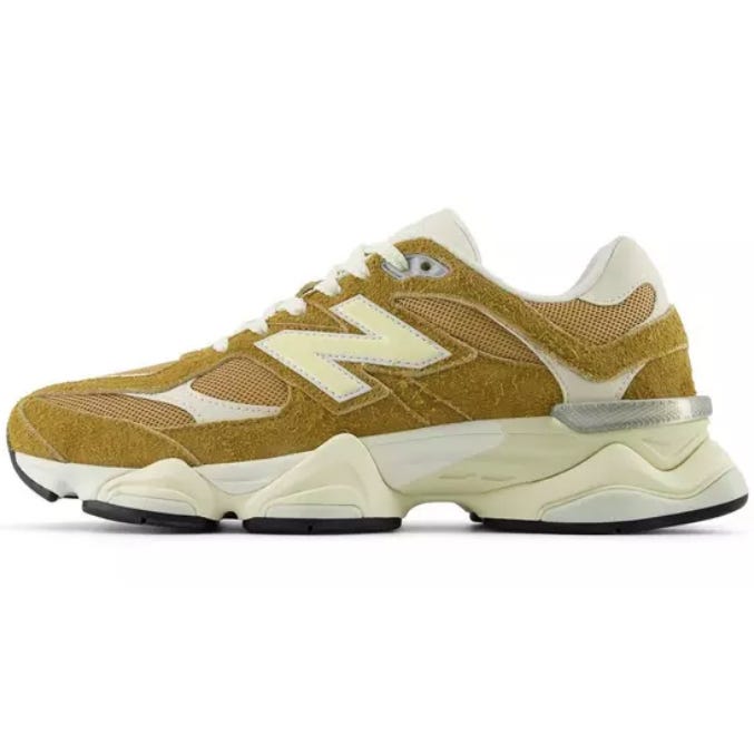 A mustard yellow New Balance sneaker with a mesh and suede upper, featuring a cream midsole and black outsole.