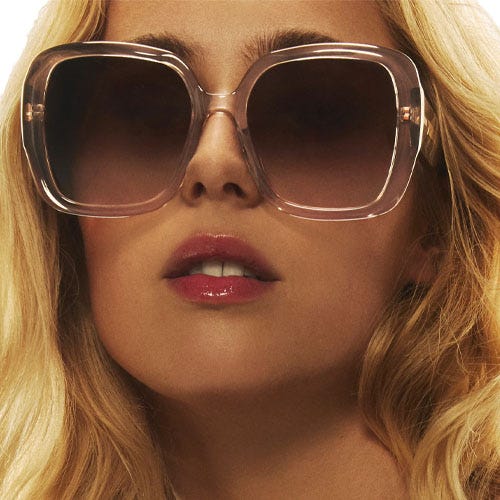 The Quay Full Glam Sunglasses feature oversized square frames with a transparent beige finish and dark gradient lenses, offering bold and stylish protection.