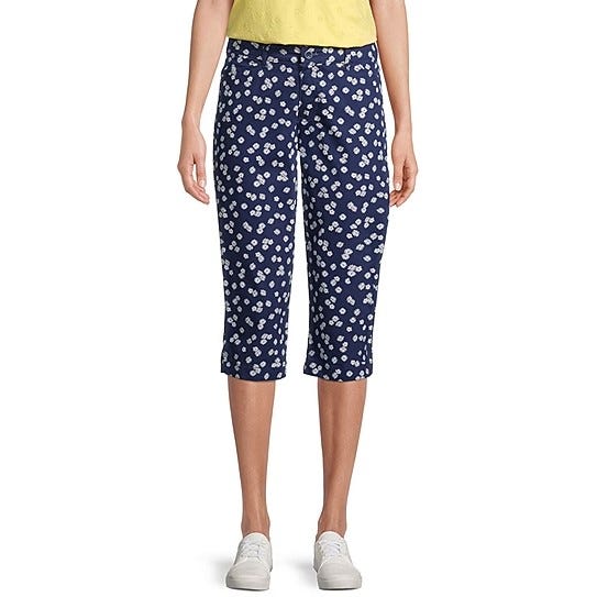 Navy blue capri pants with a white heart print, paired with a yellow top and white sneakers.
