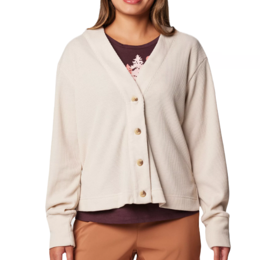 Columbia Holly Hideaway Cardigan is a beige, long-sleeve cardigan with a waffle texture, button front, and relaxed fit, perfect for layering over casual outfits.