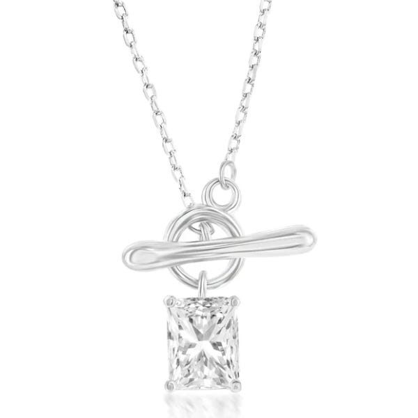 A silver necklace features a toggle clasp and a rectangular clear gemstone pendant, with a simple chain design.
