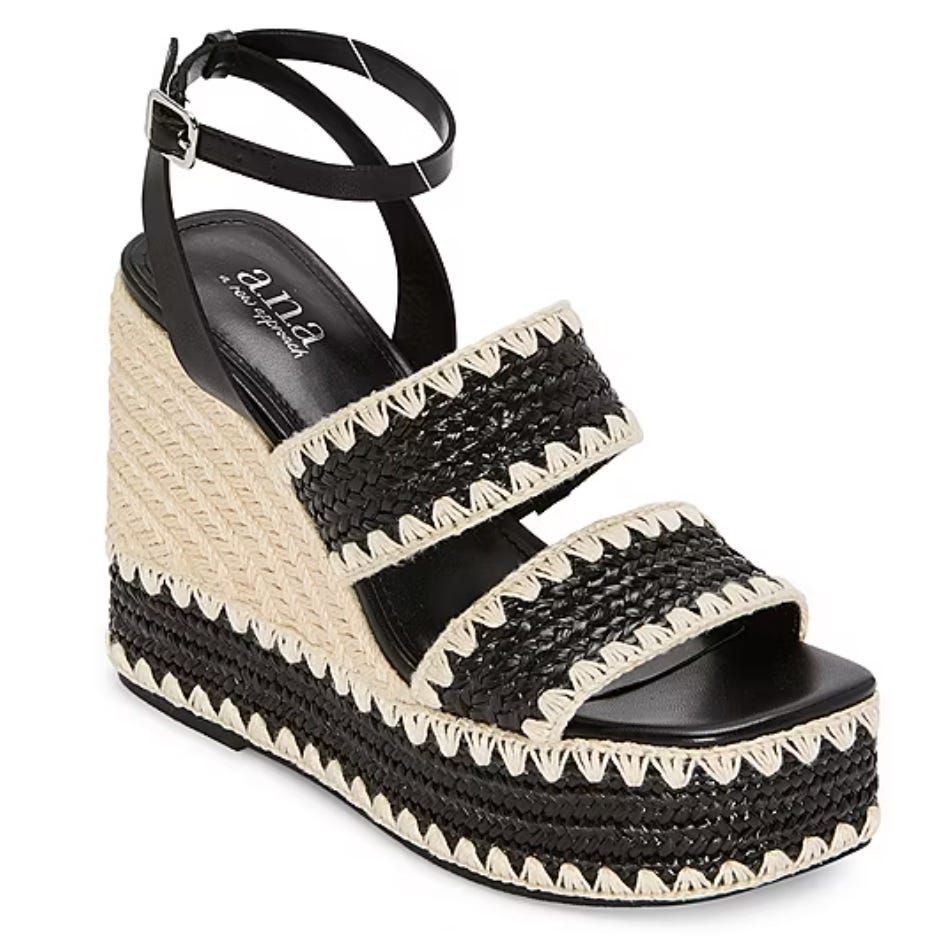 Black and beige wedge sandal with woven straps and an ankle buckle strap, featuring a jute platform for a textured look.