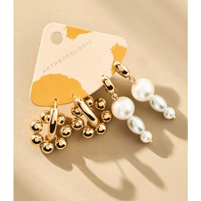Two pairs of Anthropologie earrings: one set features gold hoops with small round beads, the other includes dangling pearls of varying sizes.