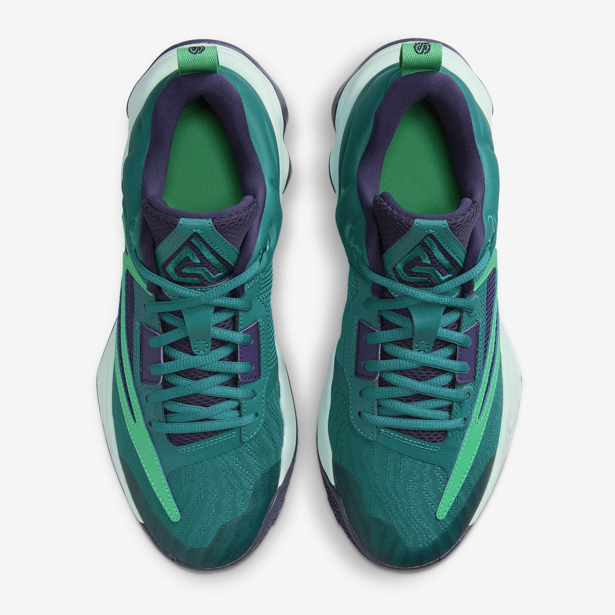 A pair of green and purple athletic sneakers viewed from above.