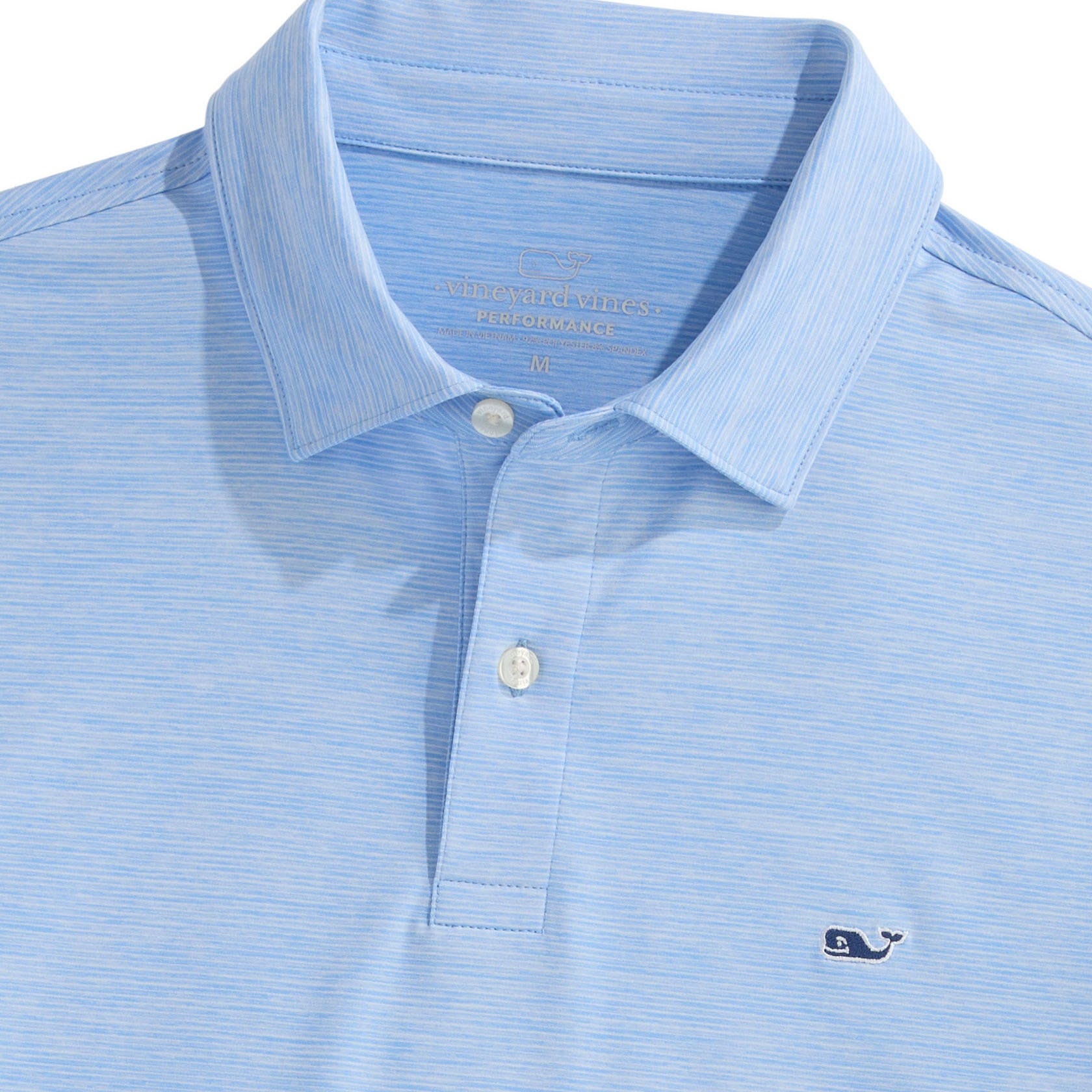 Light blue striped Vineyard Vines Performance Polo featuring a buttoned placket, ribbed collar, and embroidered whale logo on the chest.