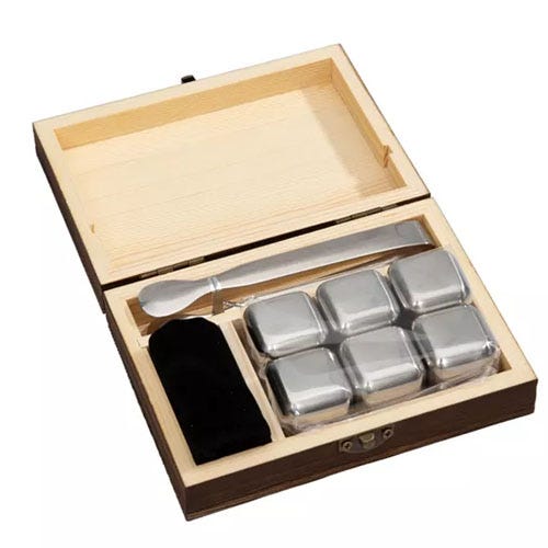 an open box displaying six whiskey stones, a spoon, and a bag
