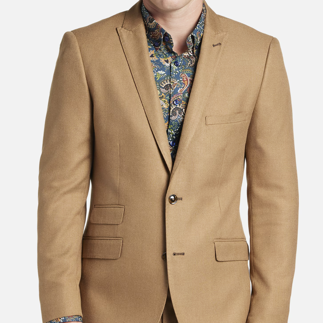 A tan blazer over a paisley patterned shirt.