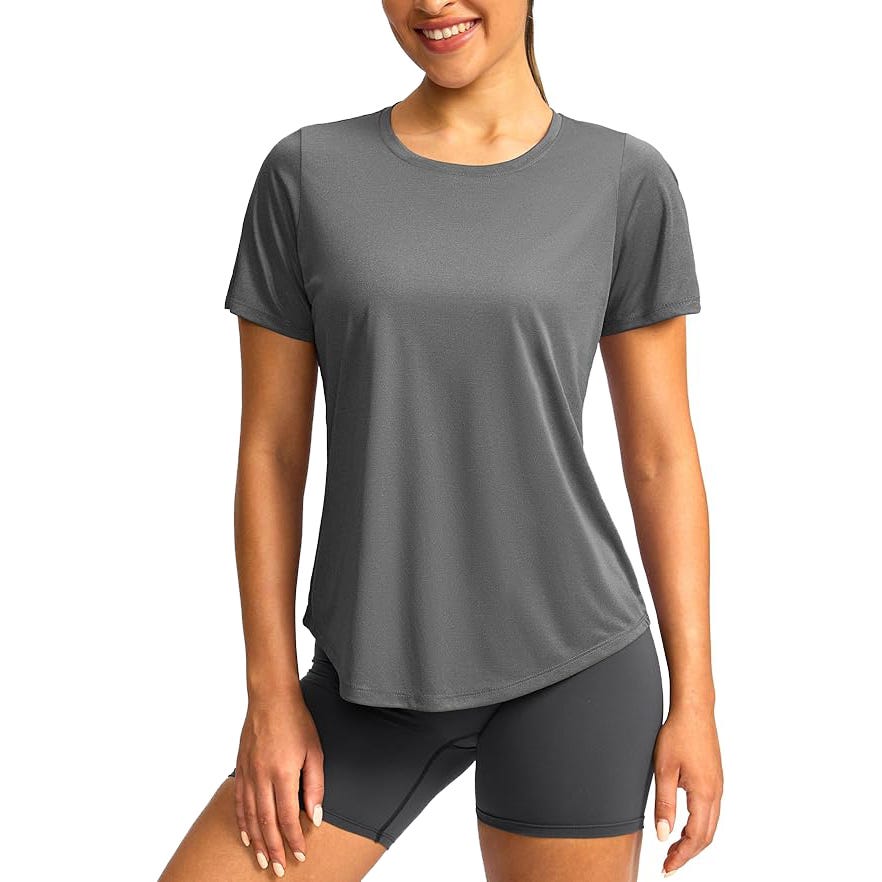 A woman is wearing a gray short-sleeve athletic t-shirt and matching gray shorts, suitable for exercise or casual wear.