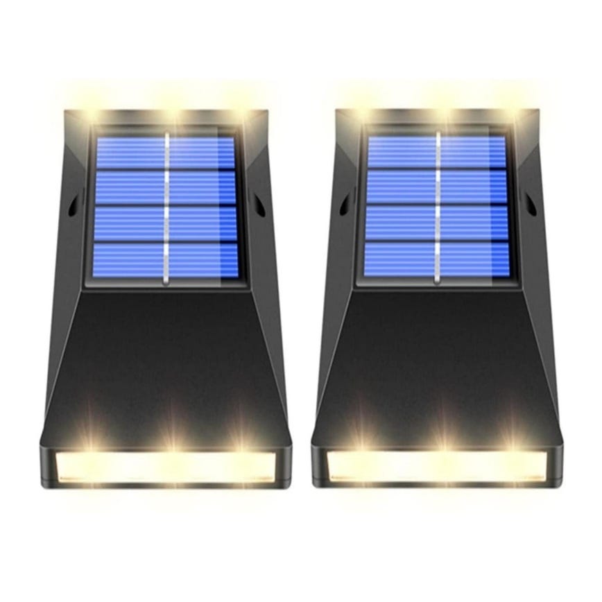 2-pack of solar LED wall lights with a sloped black design, featuring prominent solar panels on top and multiple small lights emitting warm illumination on the front.