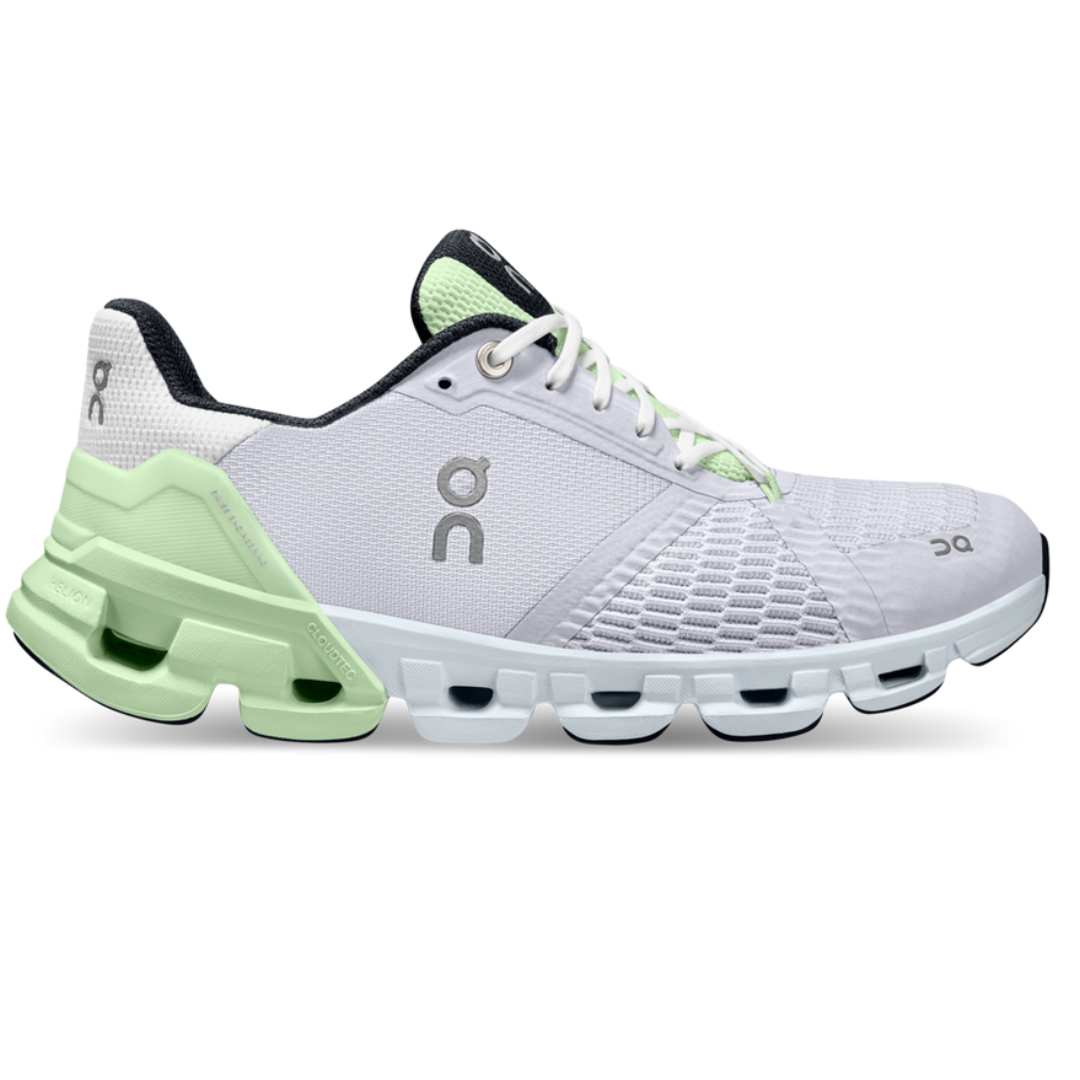 White and mint green athletic shoe with a distinctive sole design featuring circular elements and mesh ventilation, branded with a stylized \“on\“ logo.