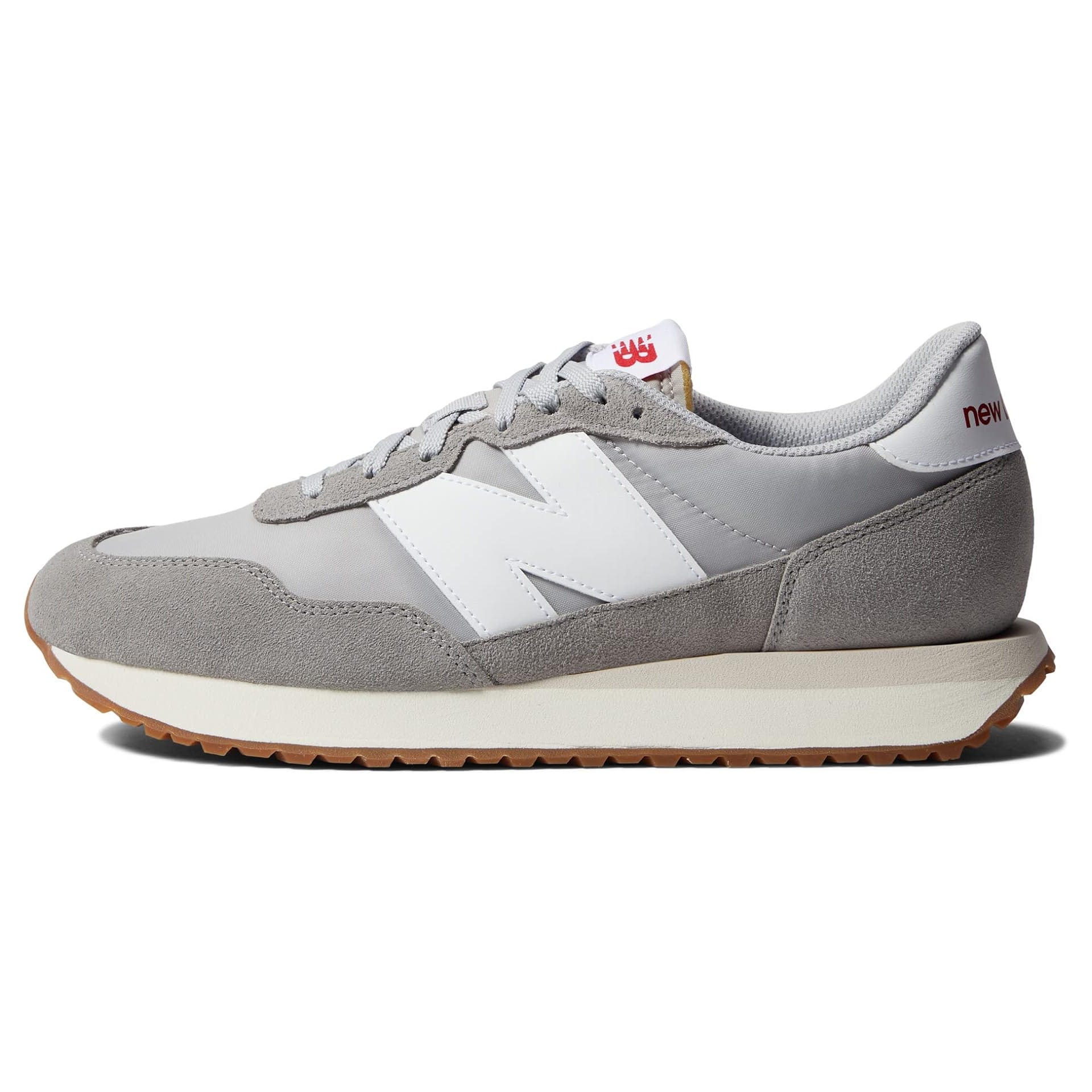 A gray suede and mesh New Balance men's classic sneaker, featuring a white \“N\“ logo, a cushioned sole, and gum rubber outsole, combining retro style with modern comfort.
