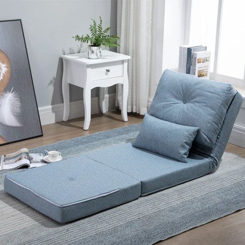 Adjustable floor lounge chair with a small matching pillow, beside a white side table with a drawer.