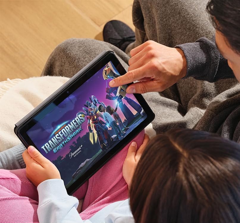 Two individuals are watching an animated Transformers show on a tablet.