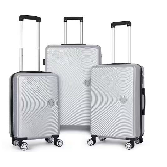 Three silver hard-shell suitcases with telescopic handles and 360-degree spinner wheels, featuring a circular pattern on the front.