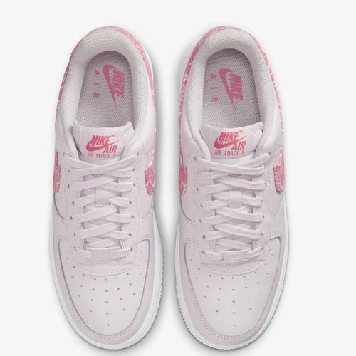 A pair of Nike Air Force 1 sneakers, predominantly white with pink accents.