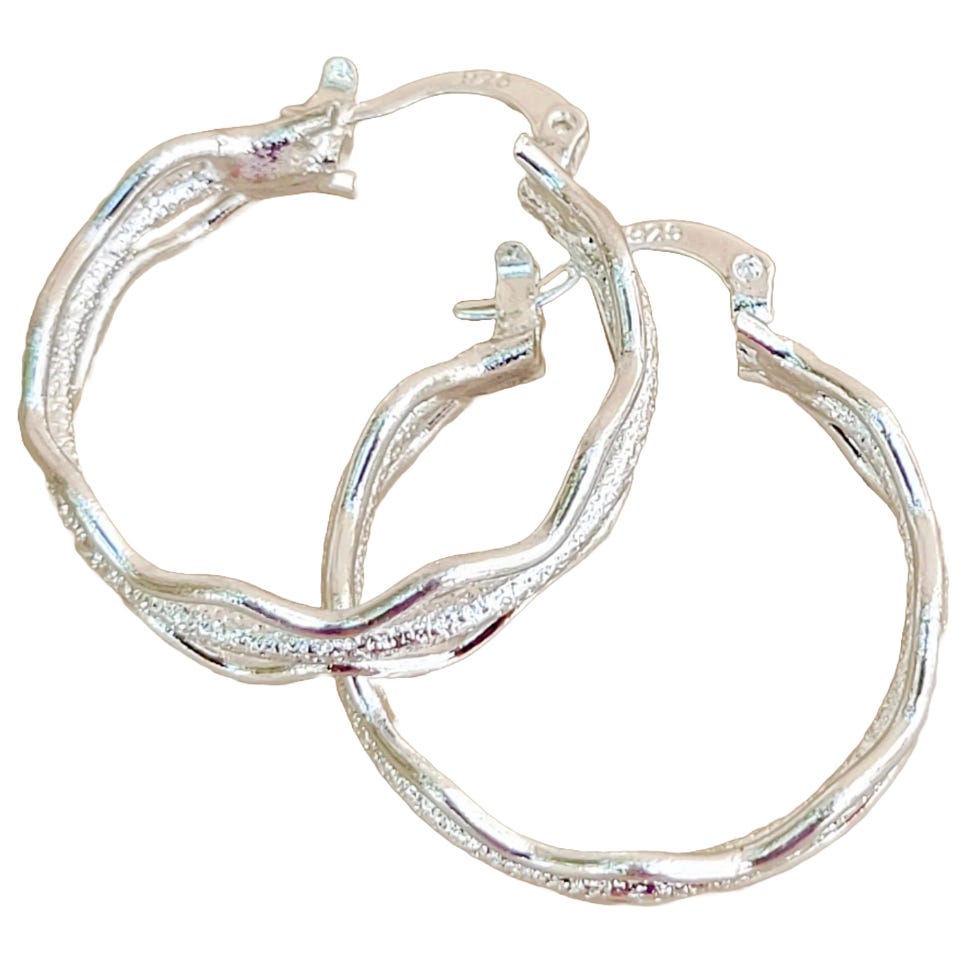 These are textured silver hoop earrings with a twisted design and a hinged closure.