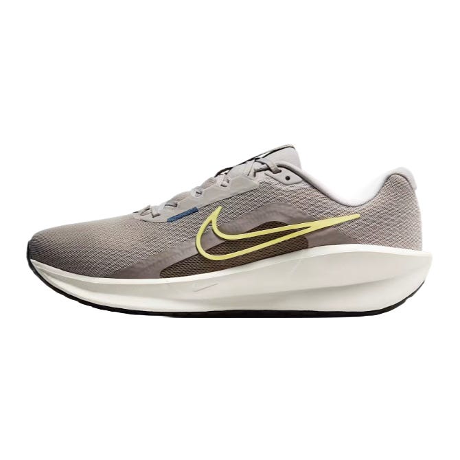 A gray and white Nike running shoe with a yellow swoosh logo.