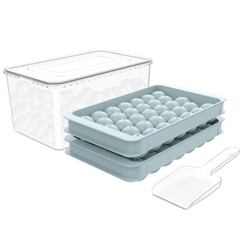A set of two round ice cube molds stacked on top of each other alongside a white scoop and a clear storage container with a lid.