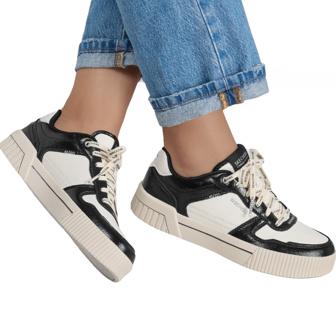 Skechers Jade Twilight Tones Shoes feature a black and white design with a chunky sole, lace-up closure, and branded laces, offering a modern, sporty look.