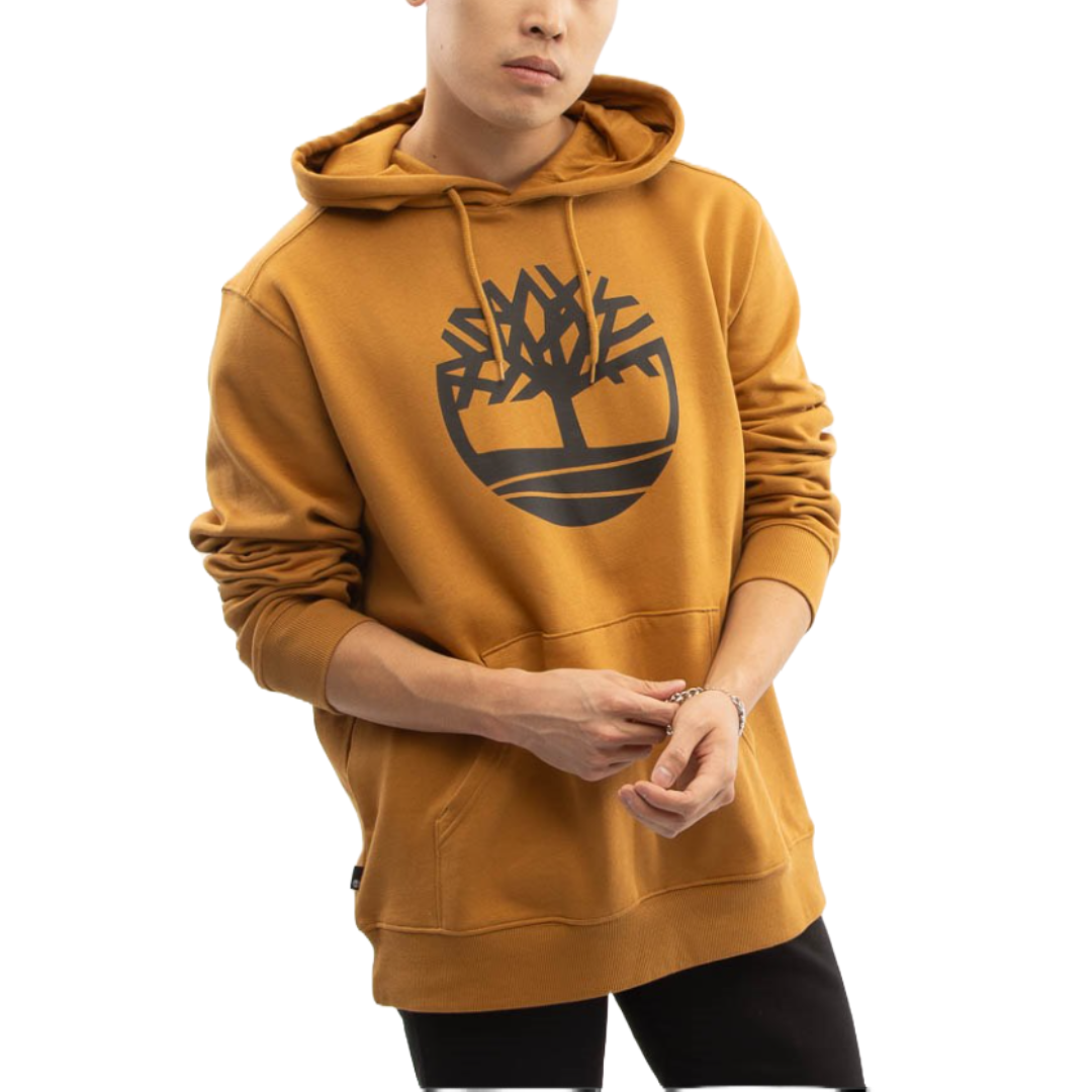 Brown hoodie featuring a large, black Timberland tree logo on the chest, with a drawstring hood and ribbed cuffs, worn by a standing person.