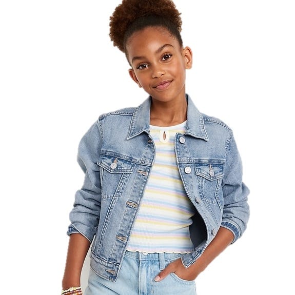 A young girl is wearing a light blue denim jacket over a striped top with light blue pants, accessorized with a colorful bracelet.