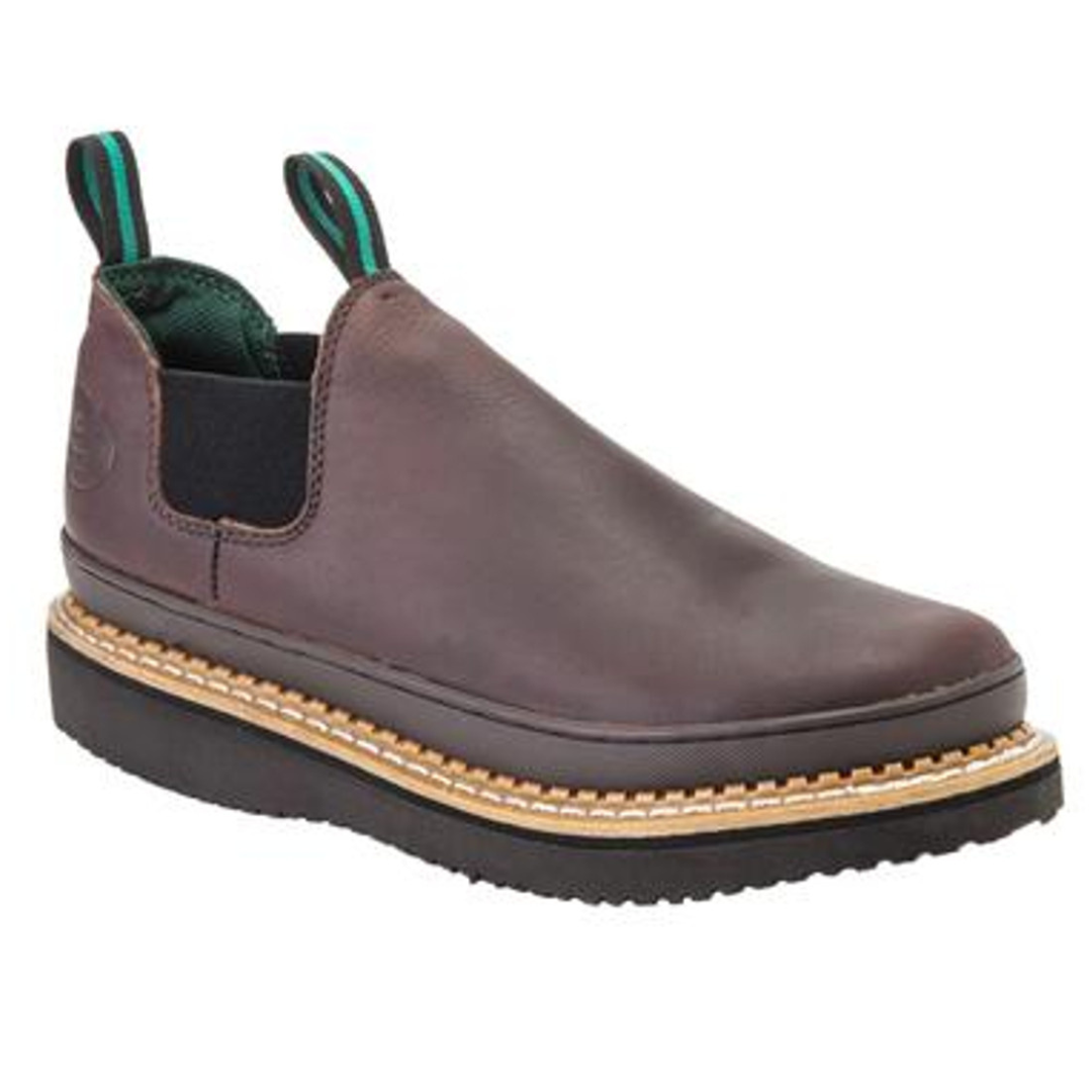 Brown slip-on leather boots with dual pull tabs and black elastic side panels, featuring a pronounced layered sole with stitching detail.