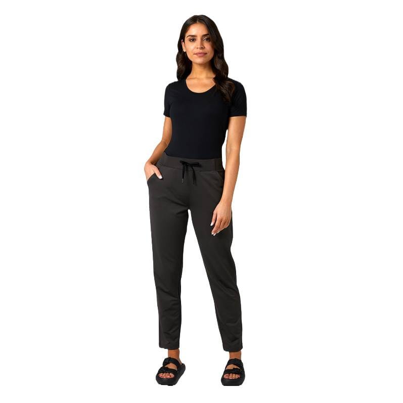A woman is wearing a black t-shirt with dark pants featuring a drawstring waist, along with black sandals.