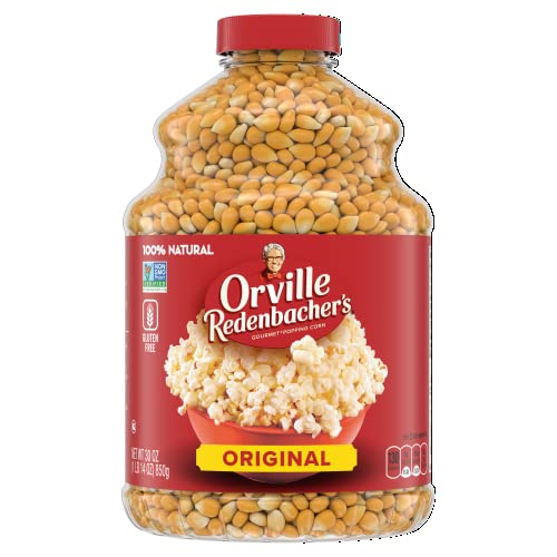A clear plastic jar filled with yellow popcorn kernels, with a red label featuring the Orville Redenbacher's brand and an image of popped popcorn.