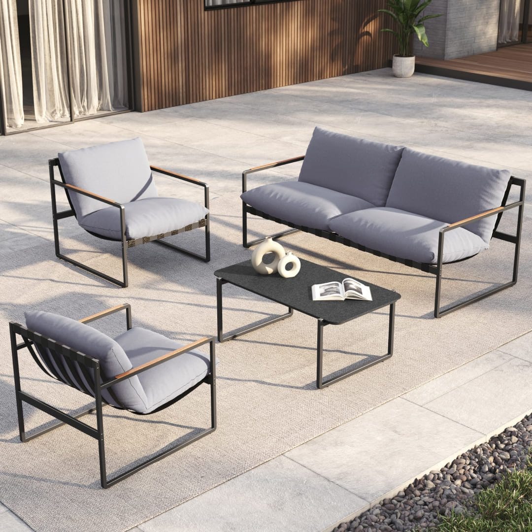 Outdoor furniture set with a sofa, two chairs, and a coffee table, all with metal frames and gray cushions.